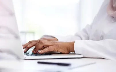 Cropped shot of an unrecognizable female doctor working on a laptop in her office in the hospital